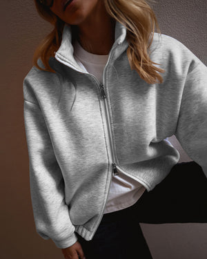 Abrigo de mujer con cremallera frontal bidireccional, bajo elástico, cuello alto, hombros caídos y diseño tipo sudadera con bolsillos